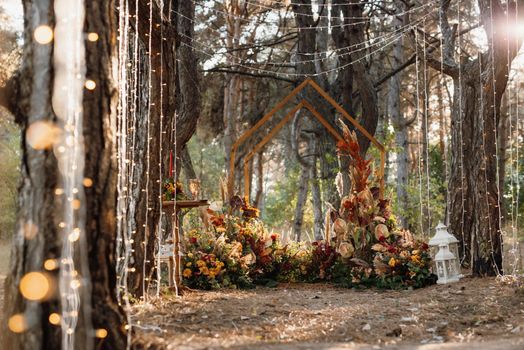 wedding ceremony area with dried flowers in a meadow in a pine brown forest