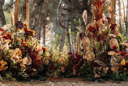 wedding ceremony area with dried flowers in a meadow in a pine brown forest