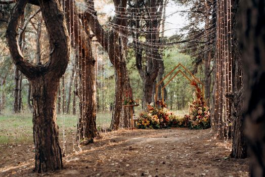 wedding ceremony area with dried flowers in a meadow in a pine brown forest