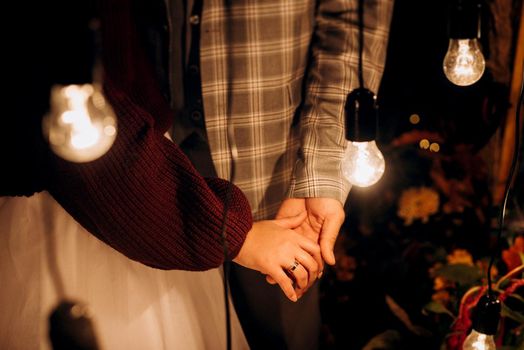 the bride and groom tenderly hold hands between them love and relationships