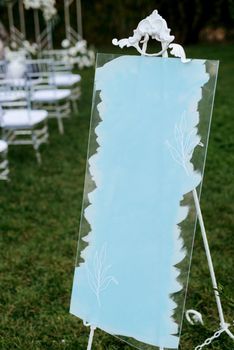 seating card for guests at the banquet on a glass blue surface