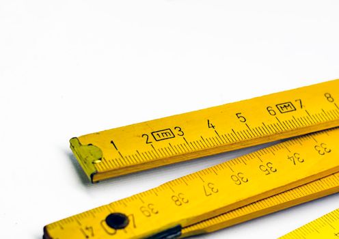 Detail of a folding wooden meter. Measuring tool for construction and renovation works. Graduated scale in centimeters.