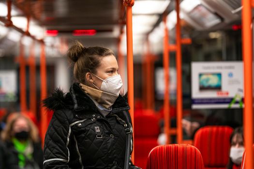 The woman travels by public transport around the city.