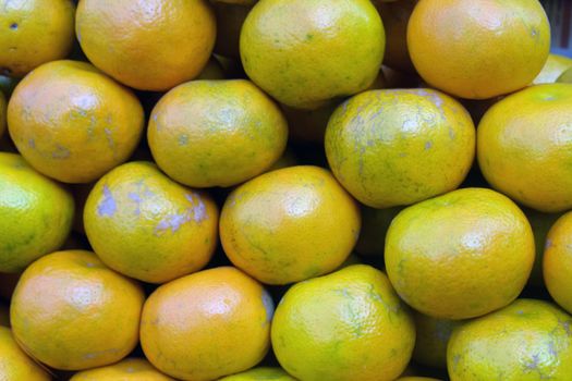 A closeup shot of fresh oranges in a market place