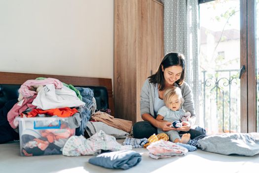 Mom and daughter are folding clothes. High quality photo