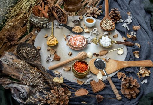 Various spices and herbs in rustic style with honey on balck background. Natural herbs medicine, Organic herbal and healthy concept, Selective focus.