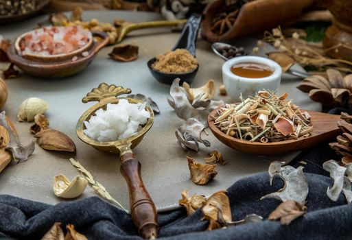 Various spices and herbs in rustic style with honey on balck background. Natural herbs medicine, Organic herbal and healthy concept, Selective focus.