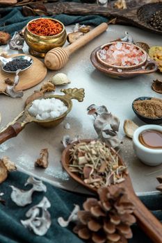 Various spices and herbs in rustic style with honey on balck background. Natural herbs medicine, Organic herbal and healthy concept, Selective focus.