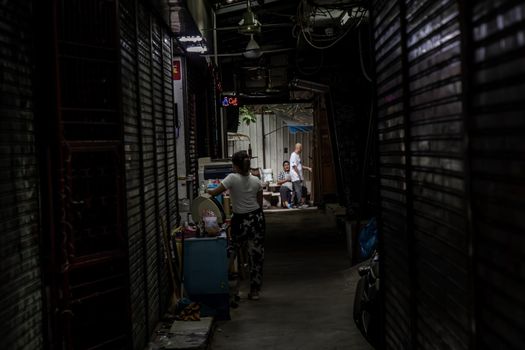 Bangkok, Thailand - Jun 19, 2020 : People live their normal lives in narrow alley at Khaosan road.