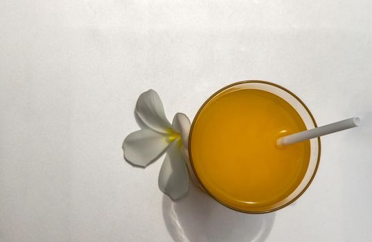 A glass of fresh orange juice for a refreshment on silver background. leisure activity.