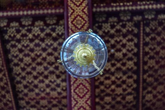 Bangkok, Thailand - Jun 19, 2020 : Beautiful lamp on the ceiling in The Temple of Emerald Buddha or Wat Phra sri rattana sasadaram.