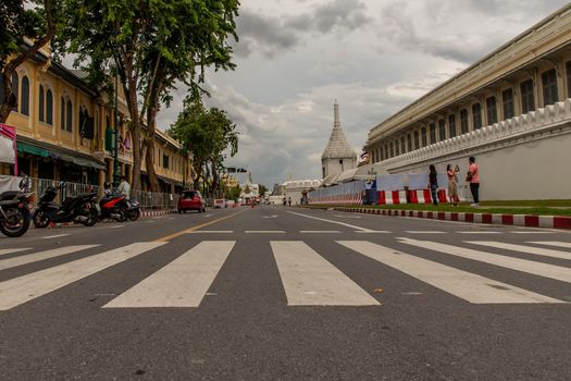 Bangkok, Thailand - Jun 19, 2020 : The road in front of Wat Phra Kaew (Temple of Emerald Buddha) and Grand Palace With a long white wall. And with the background of the sky in Bangkok.