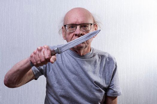 Wearing glasses and baldness. The knife is a huge kitchen meat.