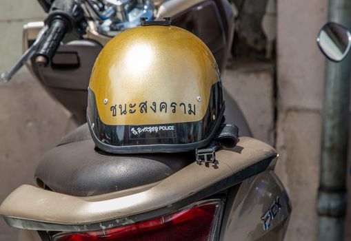 Bangkok, Thailand - Jun 19, 2020 : A Thailand police helmet on the saddle of a police motorcycle at Chana Songkhram Metropolitan Police Station. Police hat.