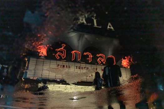 Bangkok, Thailand, Jul 03, 2020 : The reflextion of Scala cinema logo in water puddle after the rain.