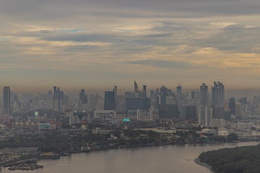 Bangkok, Thailand - Jun 19, 2020 : City view of Bangkok with Chao Phraya River curve. Lonely moment of the sunset. Selective focus.