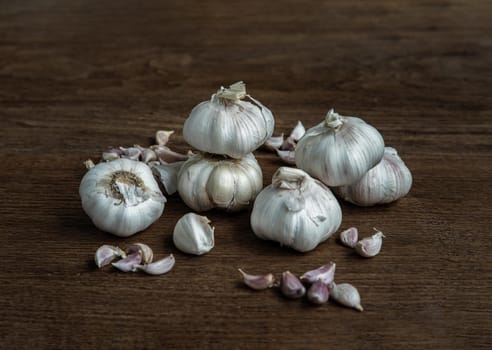 Garlic bulbs and Garlic cloves on Wooden rustic table. Copy space Concept of healthy food. Selective focus.