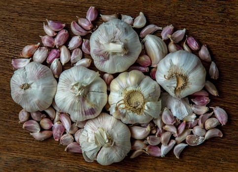 Garlic bulbs and Garlic cloves on Wooden rustic table. Copy space Concept of healthy food. Top view, Selective focus.