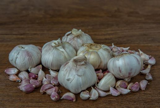 Garlic bulbs and Garlic cloves on Wooden rustic table. Copy space Concept of healthy food. Selective focus.