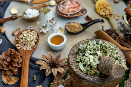 Various spices and herbs in rustic style with honey on balck background. Natural herbs medicine, Organic herbal and healthy concept, Selective focus.