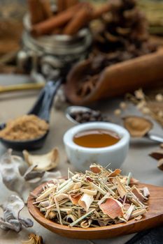 Dried lemongrass herb and Various spices in rustic style with honey on balck background. Natural herbs medicine, Organic herbal and healthy concept, Selective focus.