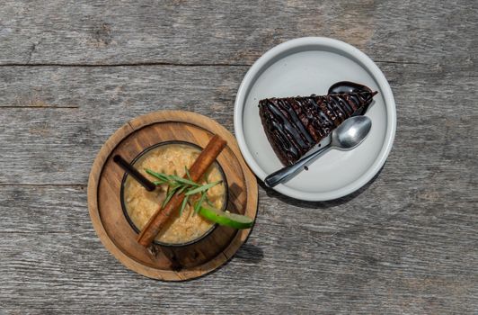 Top view of Honey lemon coffee with Chocolate Brownie Cake on wooden background. Refreshing summer food and drink  concept. Copy Space, Selective focus.