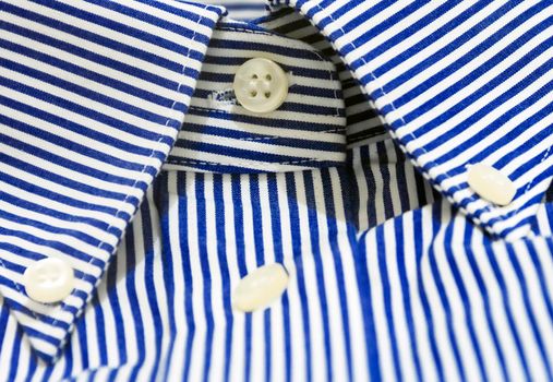 A blue striped shirt with a button down collar. Formal wear for events or work and business meetings