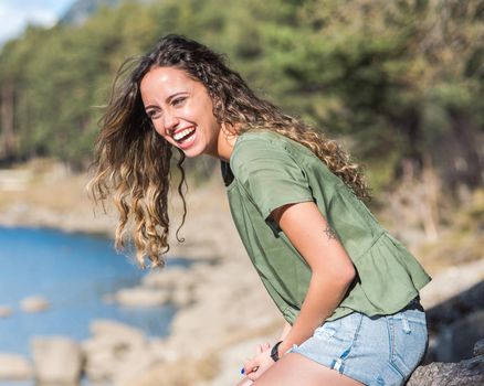 Pretty girl with curly hair in summer.