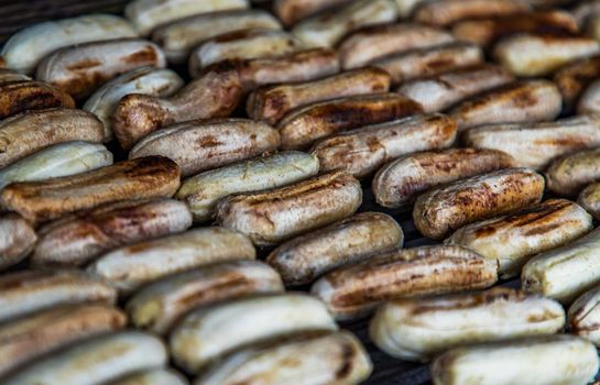 Banana roasted on charcoal stove at Street food. Grilled banana, Healthy food. Selective focuse.