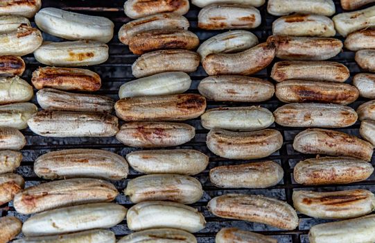 Banana roasted on charcoal stove at Street food. Grilled banana, Healthy food. Top view, Selective focuse.