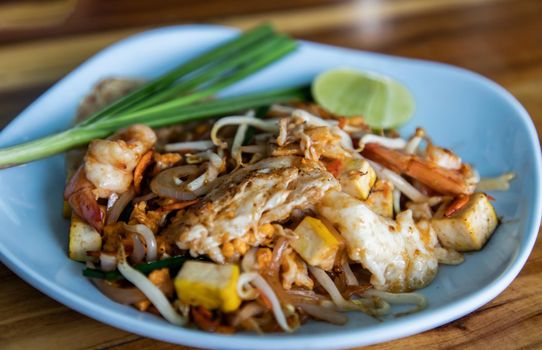 Close-up of Fried Thai Noodle with Shrimp or Pad Thai Goong Sod. That popular food for foreigner tourists. Focus and blur.