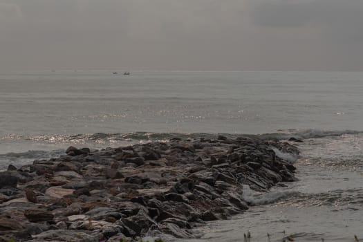 Rocks and sea : View of sea waves hitting rocks on the Calm beach in the morning. Focus and blur.