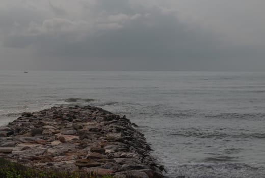 Rocks and sea : View of sea waves hitting rocks on the Calm beach in the morning. Focus and blur.