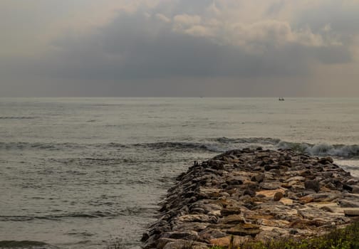Rocks and sea : View of sea waves hitting rocks on the Calm beach in the morning. Focus and blur.