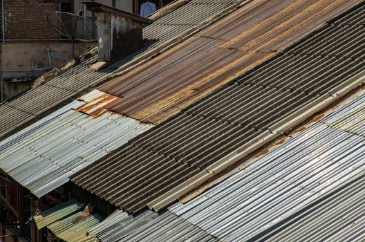 The Old galvanized roof and Old chimney roof on House, Old metal sheet roof texture, Rusty metal sheet texture. Selective focus.