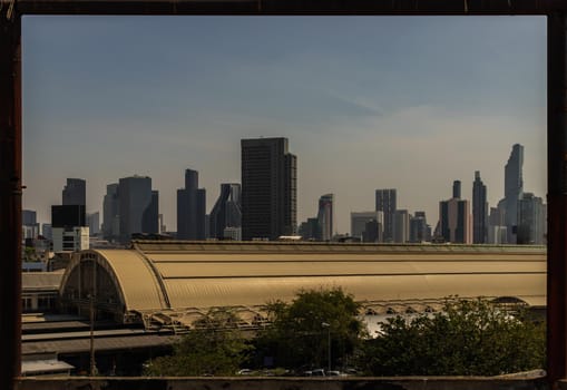 Roof of Hua Lamphong Station And the sky background of Bangkok. Looks through the Steel frame in abandoned building. No focus, specifically.
