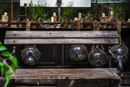 Candlestick and plant pot on wooden table with Wooden chair for sit back relax. Vintage house decoration idea, Selective focus.
