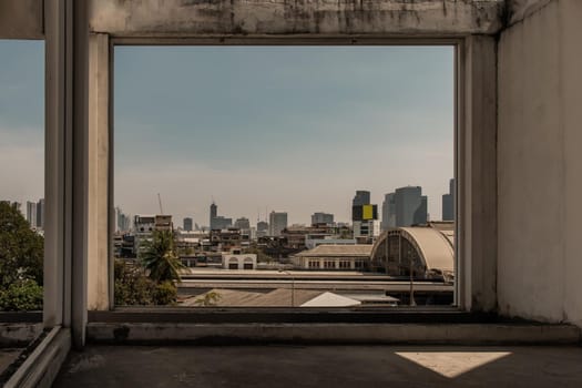 Roof of Hua Lamphong Station And the sky background of Bangkok. Looks through the window frames in abandoned building. No focus, specifically.