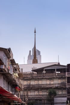 City view of Bangkok with House and Modern tall building and Thai temple that perfectly coexist. Selective focus.