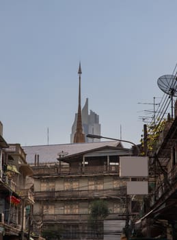City view of Bangkok with House and Modern tall building and Thai temple that perfectly coexist. Selective focus.