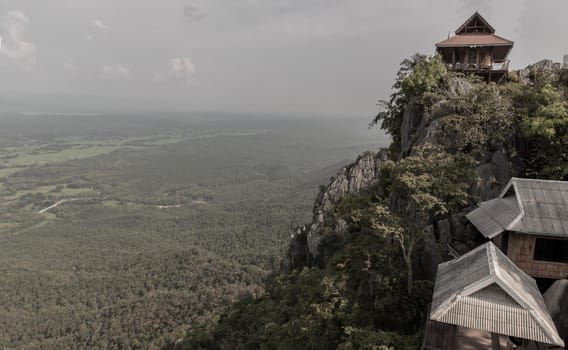 Lampang, Thailand - Sep 03, 2020 : Pagoda on top of the cliff high mountain at Chaloem Phrakiat Phrachomklao Rachanuson temple (Wat Phrabat Pu Pha Daeng) Chae-Hom District, Lampang province, Unseen and Amazing temple in Thailand. Selective focus.