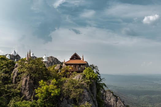 Lampang, Thailand - Sep 03, 2020 : Pagoda on top of the cliff high mountain at Chaloem Phrakiat Phrachomklao Rachanuson temple (Wat Phrabat Pu Pha Daeng) Chae-Hom District, Lampang province, Unseen and Amazing temple in Thailand. Selective focus.