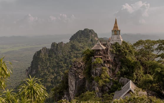 Lampang, Thailand - Sep 03, 2020 : Pagoda on top of the cliff high mountain at Chaloem Phrakiat Phrachomklao Rachanuson temple (Wat Phrabat Pu Pha Daeng) Chae-Hom District, Lampang province, Unseen and Amazing temple in Thailand. Selective focus.