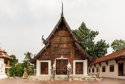 Buddhist temple in Wat Pratu Pong at Lampang Province. An ancient temple decorated with ancient Lanna art, Selective focus.