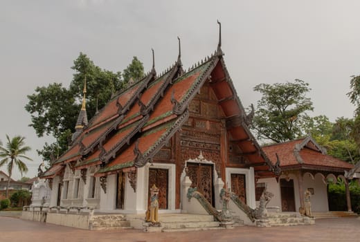 Buddhist temple in Wat Pratu Pong at Lampang Province. An ancient temple decorated with ancient Lanna art, Selective focus.