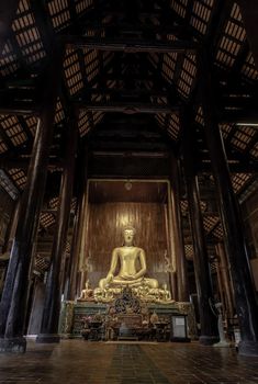 Chiangmai, Thailand - Sep 07, 2020 : The buddha image in main vihan at wat phun tao. Wat phan tao is a beautiful wooden temple in chiang mai. Selective focus.