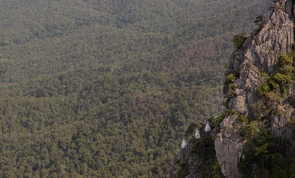 Lampang, Thailand - Sep 03, 2020 : Pagoda on top of the cliff high mountain at Chaloem Phrakiat Phrachomklao Rachanuson temple (Wat Phrabat Pu Pha Daeng) Chae-Hom District, Lampang province, Unseen and Amazing temple in Thailand. Selective focus.