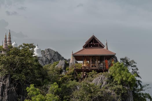 Lampang, Thailand - Sep 03, 2020 : Pagoda on top of the cliff high mountain at Chaloem Phrakiat Phrachomklao Rachanuson temple (Wat Phrabat Pu Pha Daeng) Chae-Hom District, Lampang province, Unseen and Amazing temple in Thailand. Selective focus.
