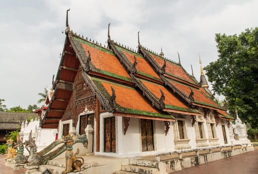 Buddhist temple in Wat Pratu Pong at Lampang Province. An ancient temple decorated with ancient Lanna art, Selective focus.