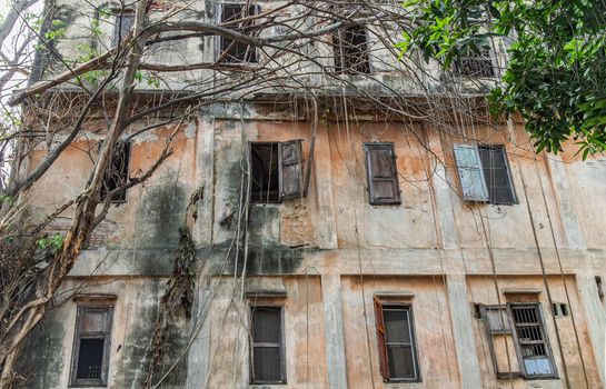 External of old building was left to deteriorate over time, Traditional architecture style, Old abandoned house, Destroyed house, Ruined house. Selective focus.